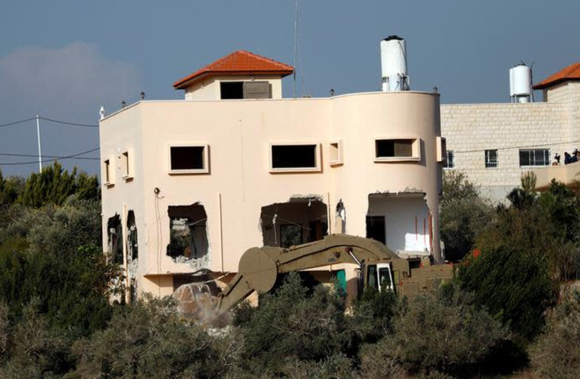 Israeli forces demolish part of the family house of Palestinian gunman Ashraf Naalwa in the village of Shweikeh near Tulkarm, in the West Bank December 17, 2018 (photo credit: MOHAMAD TOROKMAN/REUTERS)