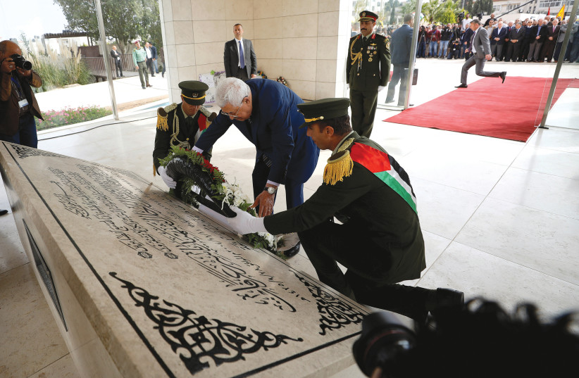 PALESTINIAN AUTHORITY President Mahmoud Abbas lays a wreath on the tomb of late Palestinian leader Yasser Arafat. (photo credit: REUTERS)