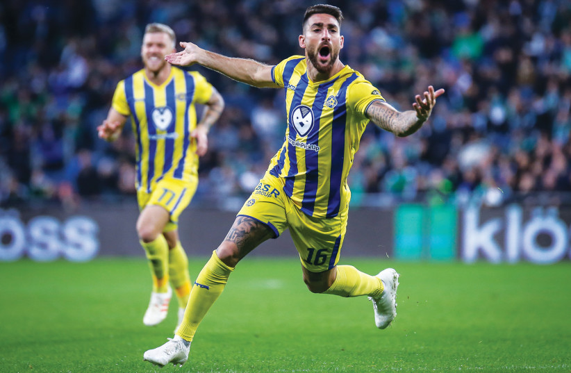 MACCABI TEL AVIV’S Eliran Atar celebrates his second goal of the game in the yellow-and-blue’s 3-1 victory over Maccabi Haifa on Monday night in Premier League action (photo credit: MAOR ELKASLASI)