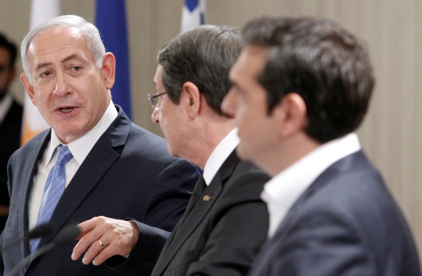 Israeli Prime Minister Benjamin Netanyahu speaks during a news conference with Cypriot President Nicos Anastasiades and Greek Prime Minister Alexis Tsipras at the Presidential Palace in Nicosia, Cyprus May 8, 2018 (photo credit: YIANNIS KOURTOGLOU/REUTERS)