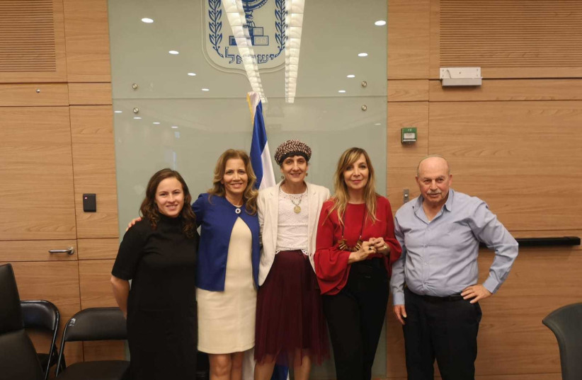 Knesset Members pose to mark the passing of a new law criminalizing prostitution on Tuesday, December 25, 2018 (photo credit: KNESSET)