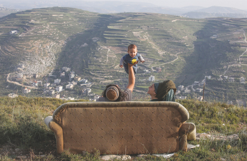 THIS PHOTO by Marc Israel Sellem from ‘The Jerusalem Post’ of a young family in Yitzhar won first prize in the Society and Community singles section. (photo credit: MARC ISRAEL SELLEM)