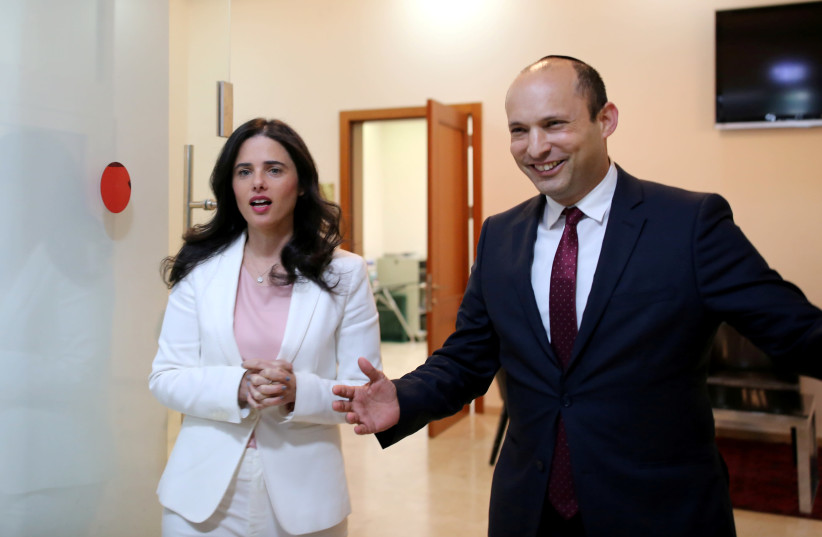 Israeli Education Minister Naftali Bennett (R) and Justice Minister Ayelet Shaked enter the room before delivering their statements in Tel Aviv, Israel December 29, 2018 (photo credit: CORINNA KERN/REUTERS)