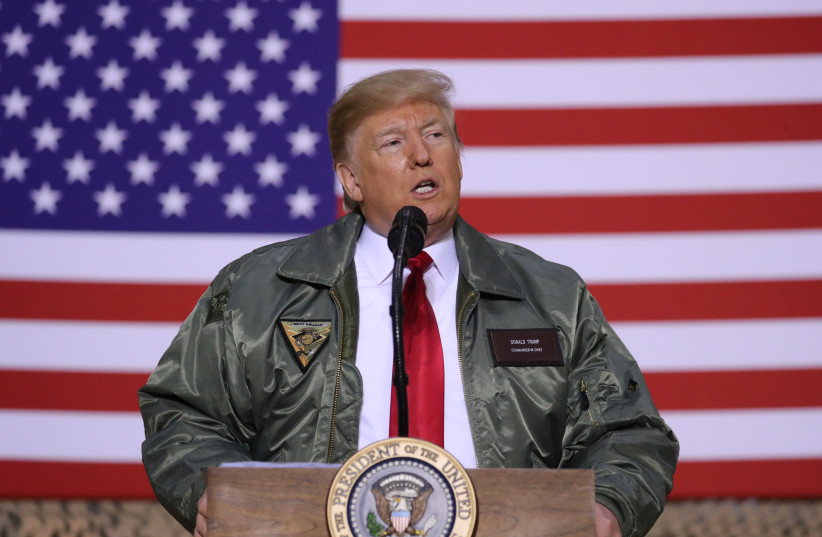U.S. President Donald Trump delivers remarks to U.S. troops in an unannounced visit to Al Asad Air Base, Iraq December 26, 2018.  (photo credit: REUTERS/JONATHAN ERNST)