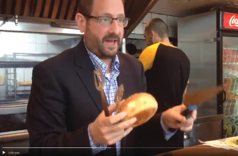 A VIDEO posted on Twitter by former MK Dov Lipman, an immigrant from the US, showing him at a restaurant in Tel Aviv asking in Hebrew, ‘Do you want fries with that?’ (photo credit: screenshot)