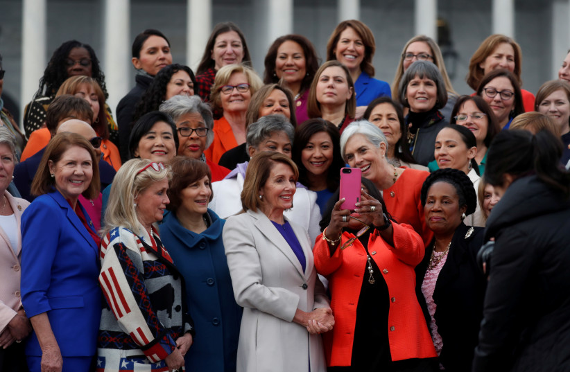 U.S. House Speaker Nancy Pelosi (D-CA) poses for a selfie during a photo opportunity with House Democratic women of the 116th Congress on Capitol Hill in Washington, U.S., January 4, 2019 (photo credit: LEAH MILLIS/REUTERS)