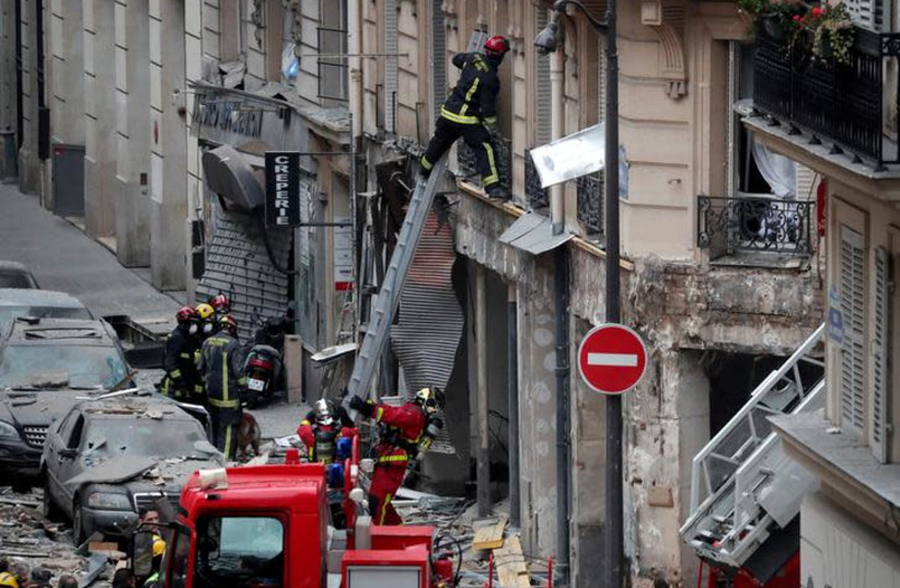 Firemen work at the site of an explosion in a bakery shop in the 9th District in Paris, France, January 12, 2019 (photo credit: REUTERS/BENOIT TESSIER)