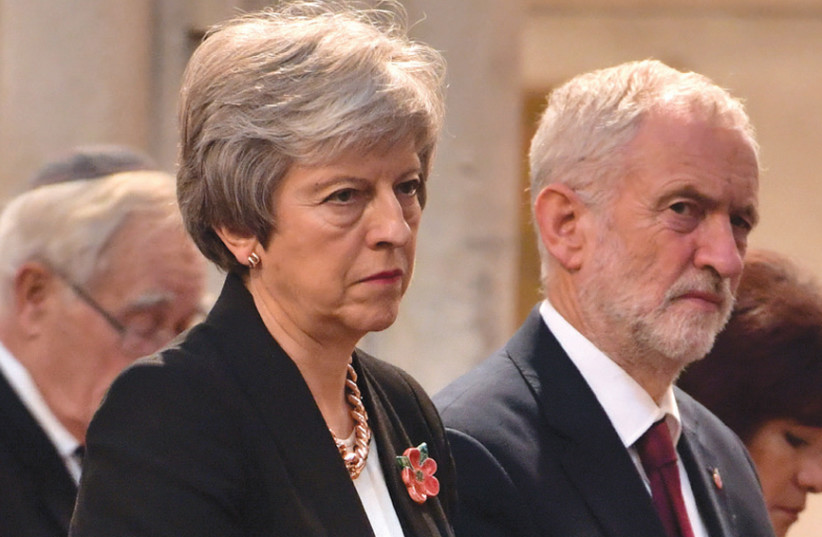 Britain’s Prime Minister Theresa May and the leader of opposition Labour Party, Jeremy Corbyn, attend an Armistice remembrance service at St Margaret’s Church in London on November 6, 2018 (photo credit: JOHN STILLWELL / POOL / VIA REUTERS)