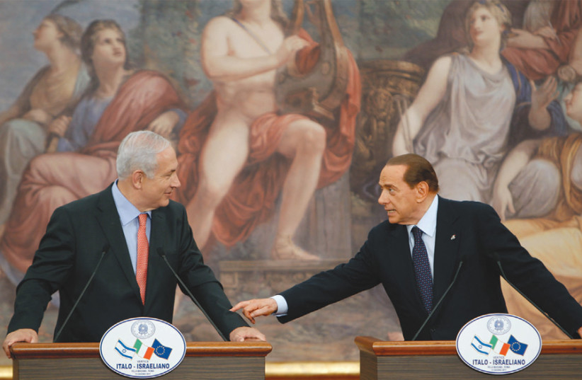 Italy’s then-prime minister Silvio Berlusconi gestures during a news conference with his Israeli counterpart, Benjamin Netanyahu, at Villa Madama in Rome, in 2011 (photo credit: STEFANO RELLANDINI/REUTERS)