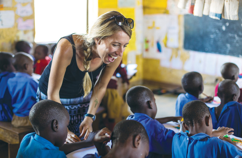 GIVINGWAY WORKS with an education NGO in a Ugandan classroom (photo credit: BEAU OUTTERIDGE)