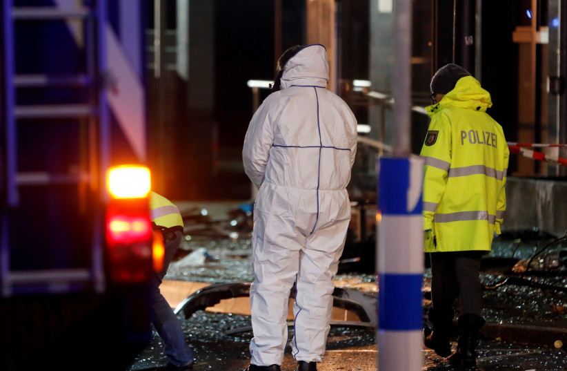 Police officers inspect a crime scene in Germany (photo credit: LEON KUEGELER/REUTERS)