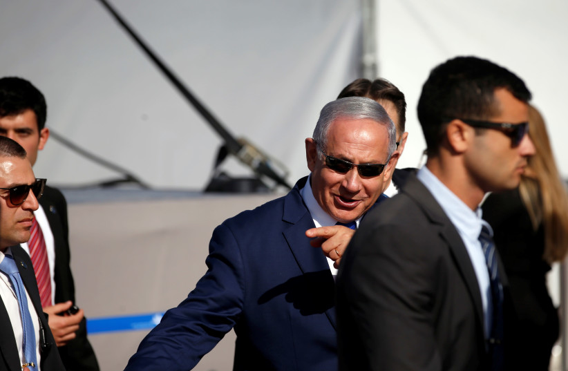 Israeli Prime Minister Benjamin Netanyahu gestures during an inauguration ceremony of the Ramon International Airport just outside the southern Red Sea resort city of Eilat, Israel January 21, 2019 (photo credit: RONEN ZVULUN/REUTERS)