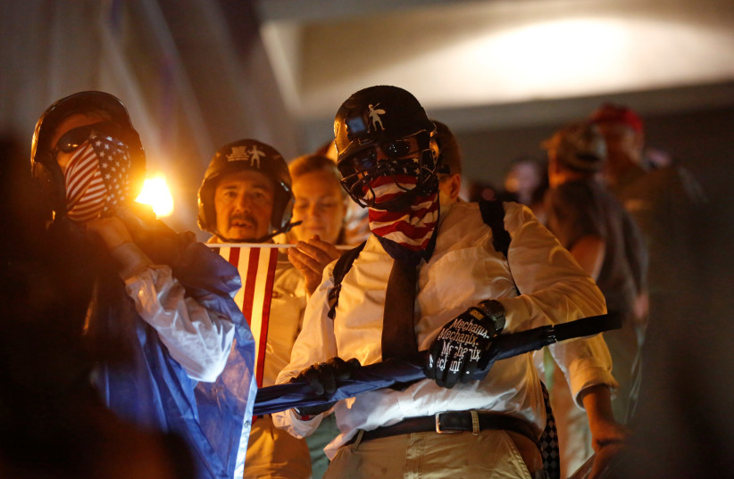 Supporters of white nationalist leader Jason Kessler arrive to take a subway to leave the area after a Washington, D.C. rally marking the one year anniversary of the 2017 Charlottesville ‘Unite the Right’ protests, while en route to Vienna, Virginia, U.S. August 12, 2018 (photo credit: REUTERS)
