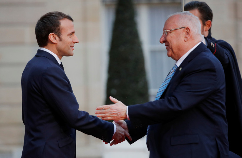 French President Emmanuel Macron welcomes Israeli President Reuven Rivlin as he arrives for a meeting at the Elysee Palace in Paris, France, January 23, 2019. (photo credit: PHILIPPE WOJAZER / REUTERS)
