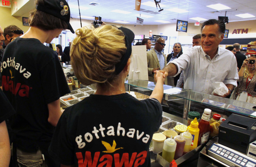 U.S. Republican Presidential candidate Romney shakes hands at store in Pennsylvania (photo credit: LARRY DOWNING/REUTERS)