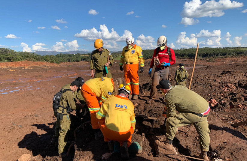 Israeli rescue workers pull bodies from the ruins in Brazil. (photo credit: Courtesy)