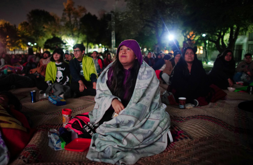 Writer Laura Sosa, 33, watches the film "Roma" projected at Los Pinos Presidential residence which was turned into a cultural centre by order of Mexico's new President Andres Manuel Lopez Obrador, Mexico City, Mexico, December 13, 2018 (photo credit: REUTERS/ALEXANDRE MENEGHINI)