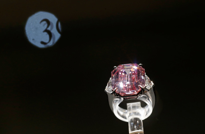 A 18.96 carat Fancy Vivid Pink Diamond is pictured at Christie's during an auction preview in Geneva, November 8, 2018.  (photo credit: DENIS BALIBOUSE / REUTERS)