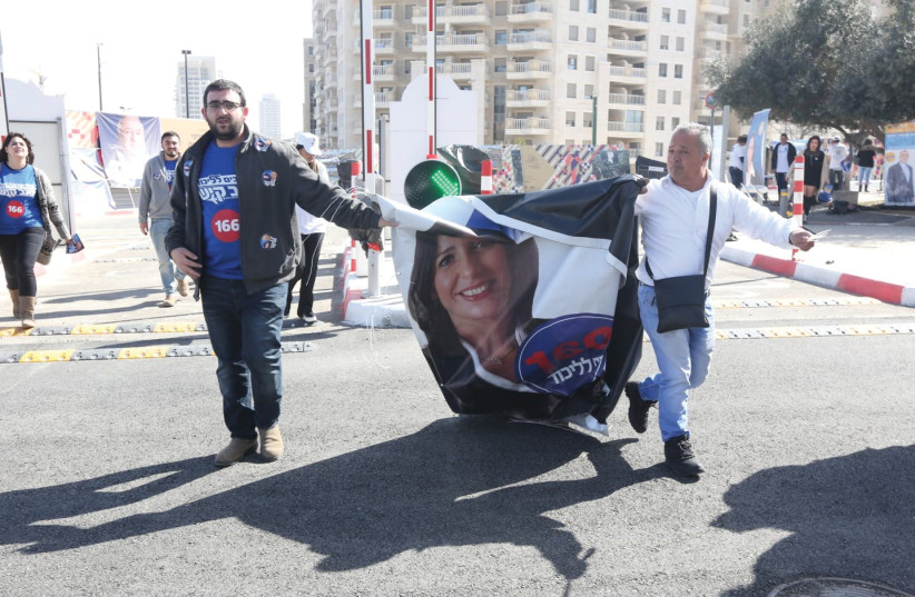 LIKUD ACTIVISTS carry a poster of Miri Regev on Tuesday, the day of the Likud primaries (photo credit: MARC ISRAEL SELLEM/THE JERUSALEM POST)