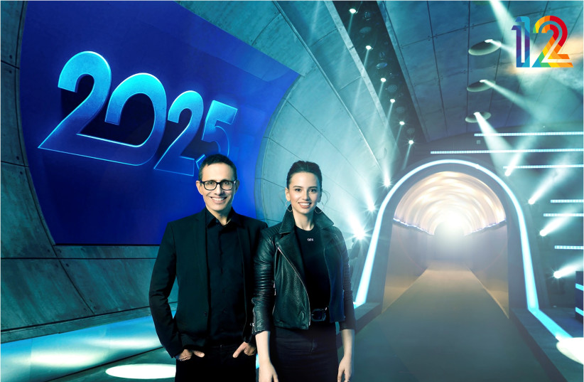Hosts Erez Tal and Corinn Gideon pose outside the entrance to the 2025 city (photo credit: TAL GIVONY)