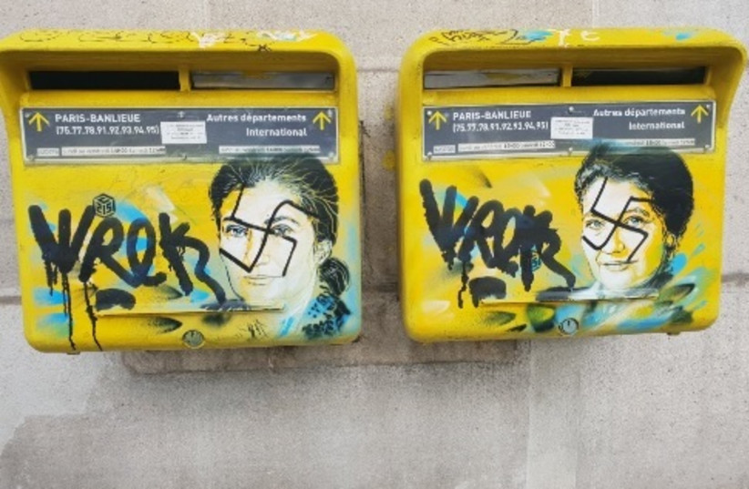 Slurs painted on the memorial art of French street artist Christian Guemy in honor of the late Simone Veiil (photo credit: screenshot)