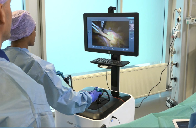 A surgeon uses a 3D Systems surgical procedure simulator (photo credit: PR)