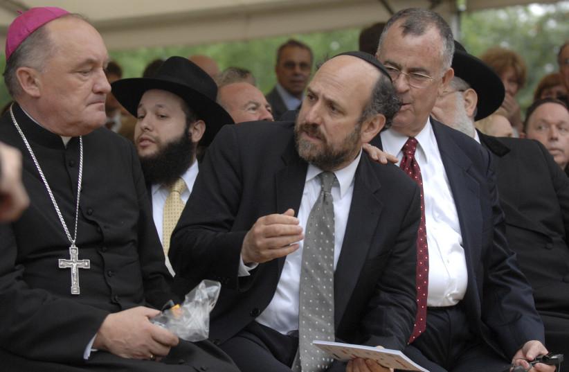 Chief Rabbi of Poland Michael Schudrich talks with Warsaw bishop Kazimierz Nycz (L) as he sits near Israel Ambassador to Poland David Peleg during the laying of the cornerstone for the Museum of the History of Polish Jews in Warsaw June 26, 2007. (photo credit: REUTERS)