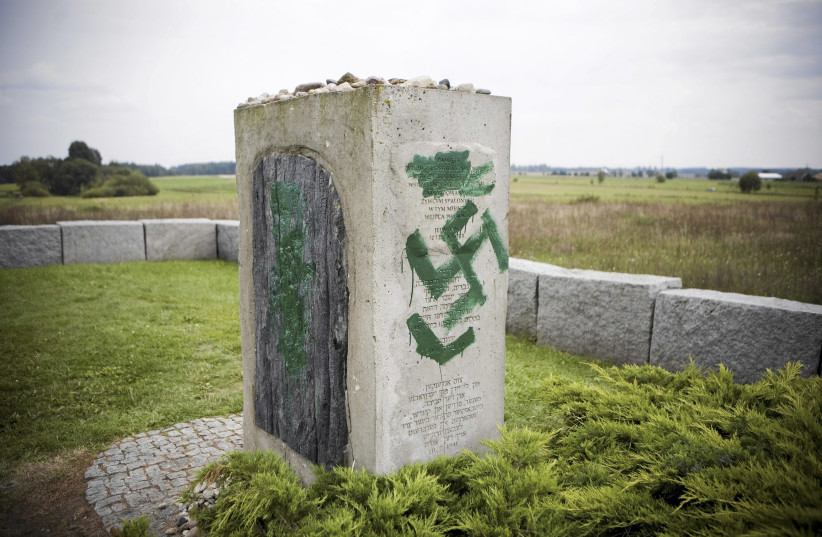 A monument with Nazi swastikas painted over it in Jedwabne (photo credit: AGENCJA GAZETA VIA REUTERS)
