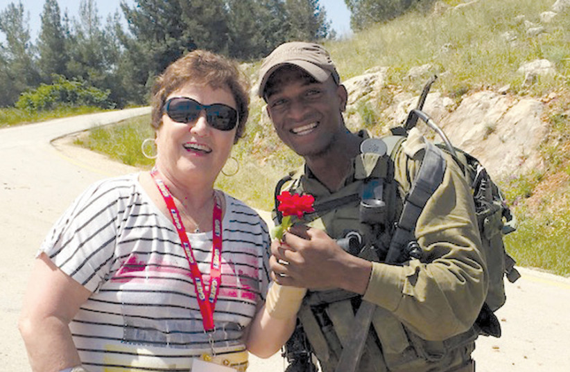 AGLOW CHIEF of strategic services Kay Rogers poses with an IDF border policeman in Metulla. (photo credit: Courtesy)