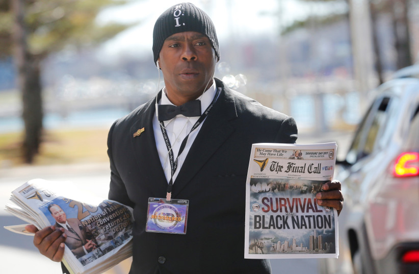Randall Muhammad sells the 'Final Call' newspaper before Religious leader Louis Farrakhan gives the keynote speech at the Nation of Islam Saviours' Day convention in Detroit, Michigan, U.S. February 19, 2017 (photo credit: REBECCA COOK / REUTERS)