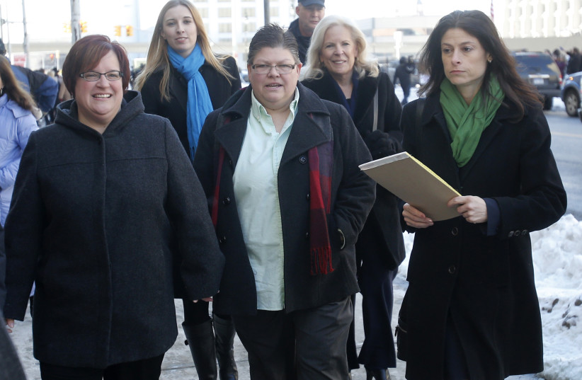 Plaintiffs April Deboer (L) and her partner Jayne Rowse leave the Federal Court with their attorney Dana Nessel (R) following closing arguments on their trial that could overturn Michigan's ban on same-sex marriage in Detroit, Michigan March 7, 2014 (photo credit: REBECCA COOK / REUTERS)