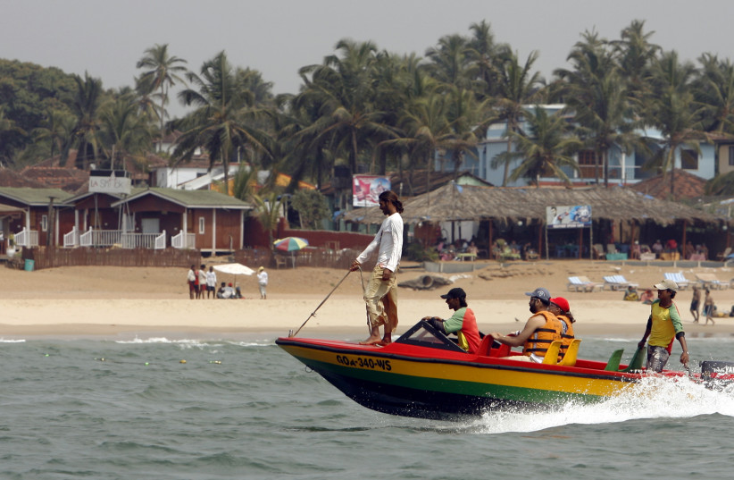 Tourists ride a boat at the Anjuna beach in the western Indian state of Goa March 14, 2008. (photo credit: PUNIT PARANJPE / REUTERS)