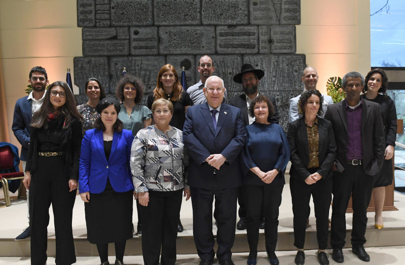 President Reuven Rivlin with the twelve doctoral students who received a prize for their theses (photo credit: MARK NEYMAN/GPO)
