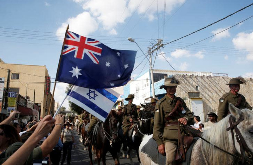 People wave Australian and Israelis flags (photo credit: REUTERS/Ronen Zvulun)