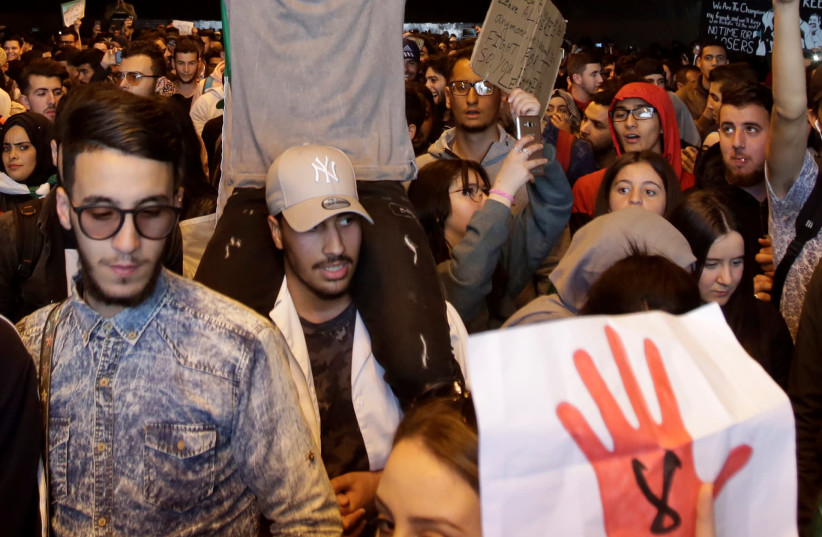 Students take part in a protest to denounce an offer by President Abdelaziz Bouteflika to run in elections next month but not to serve a full term if re-elected, in Algiers, Algeria March 5, 2019. (photo credit: RAMZI BOUDINA/REUTERS)