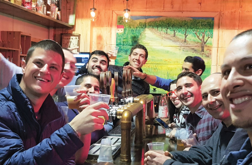 RESIDENTS OF the Lone Soldiers’ Home in Beit Shemesh visit the Buster’s Beverage Company on Moshav Nocham for a hands-on introduction to brewing. (photo credit: Courtesy)