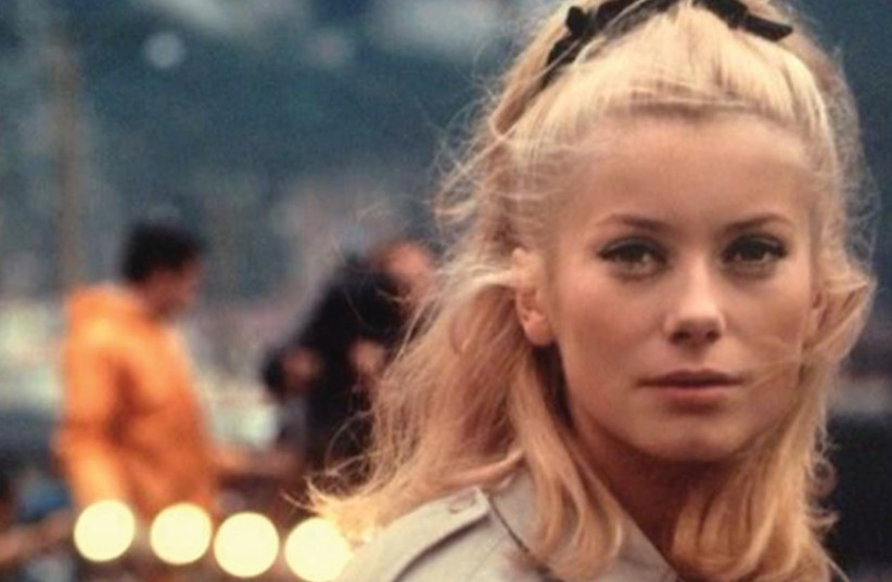 CATHERINE DENEUVE in Jacques Demy’s 1964 classic ‘The Umbrellas of Cherbourg.’ (photo credit: Courtesy)