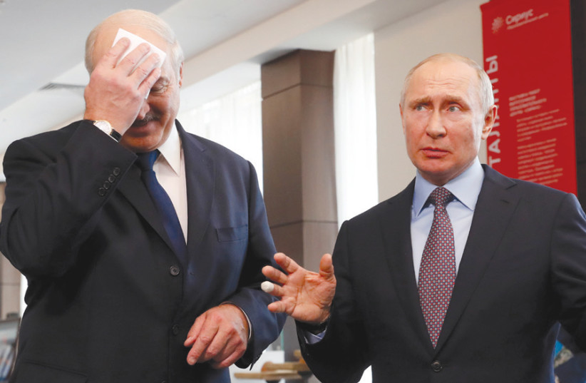 RUSSIAN PRESIDENT Vladimir Putin (right) gestures next to Belarus President Alexander Lukashenko during their meeting at the Sirius educational center, in the Black sea resort of Sochi, Russia, on February 15. (photo credit: REUTERS)