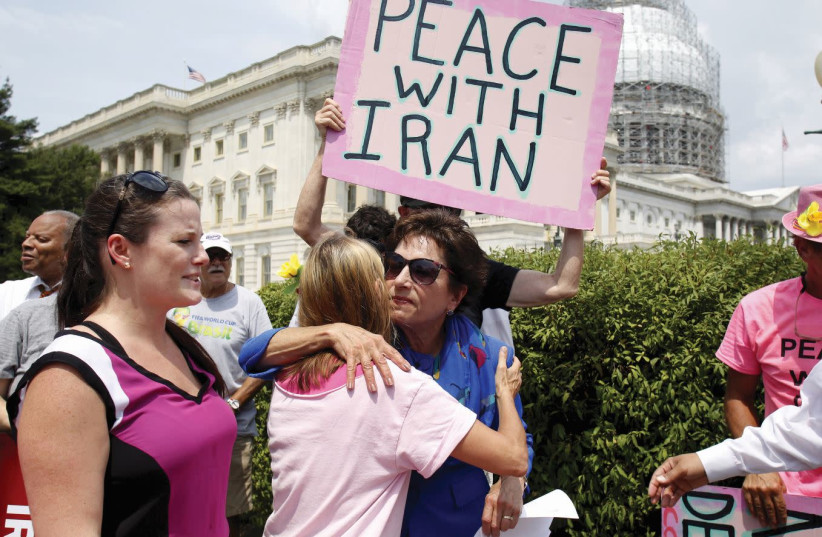 REPRESENTATIVE JAN Schakowsky (D-IL) hugs a Code Pink member at an event on Capitol Hill in Washington where activists delivered a petition in support of the Iran nuclear deal in July 2015.  (photo credit: YURI GRIPAS / REUTERS)