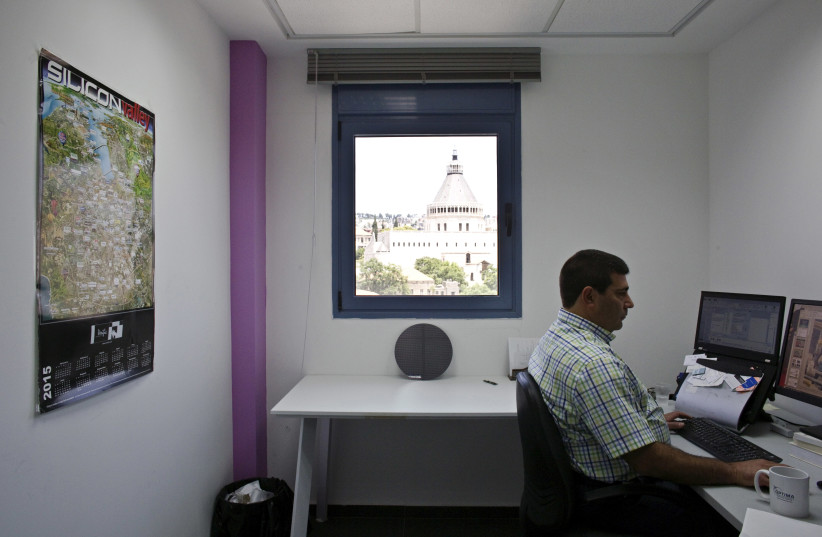 The Church of the Annunciation is seen through the office window at the Business Incubator Center in Nazareth, northern Israel June 3, 2015. (credit: REUTERS/NIR ELIAS)