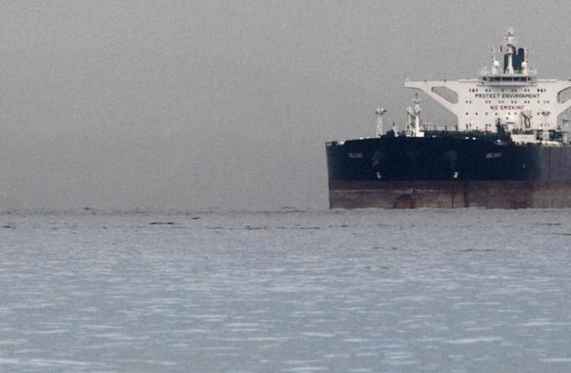 Malta-flagged Iranian crude oil supertanker "Delvar" is seen anchored off Singapore March 1, 2012. Western trade sanctions against Iran are strangling its oil exports even before they go into effect, a U.S. advisory body has found, amid warnings that any shortages will only push up crude prices and  (photo credit: REUTERS/TIM CHONG)