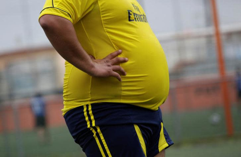 A player is pictured during his "Futbol de Peso" (Soccer of Weight ) league soccer match, a league for obese men who want to improve their health through soccer and nutritional counseling, in San Nicolas de los Garza, Mexico (photo credit: REUTERS/DANIEL BECERRIL)