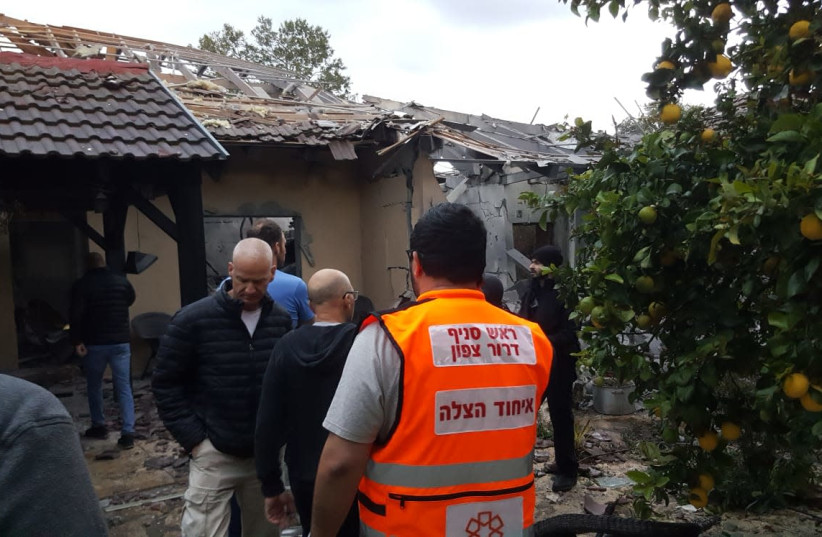 A house is taken care of by the Fire Department after being hit by rocket fire coming from the Gaza Strip, Moshav Herut, March 25, 2019. (photo credit: FIRE AND RESCUE SERVICE)