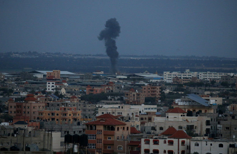 Smoke rises following an Israeli airstrike in the southern Gaza Strip March 25, 2019 (photo credit: AHMED ZAKOT / REUTERS)