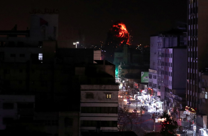 Flame and smoke are seen during an Israeli air strike in Gaza City March 25, 2019 (photo credit: REUTERS/SUHAIB SALEM)