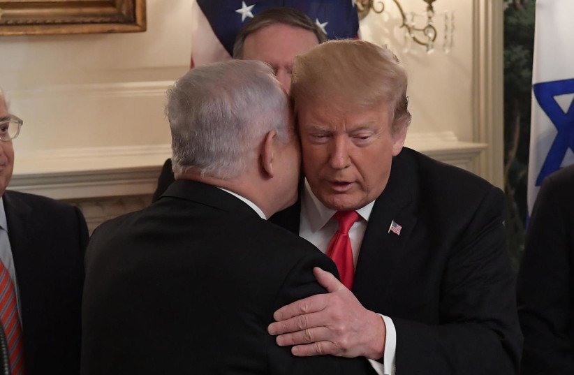 Prime Minister Benjamin Netanyahu and U.S. President Donald Trump embrace in Washington, on March 25, 2019. (photo credit: AMOS BEN-GERSHOM/GPO)