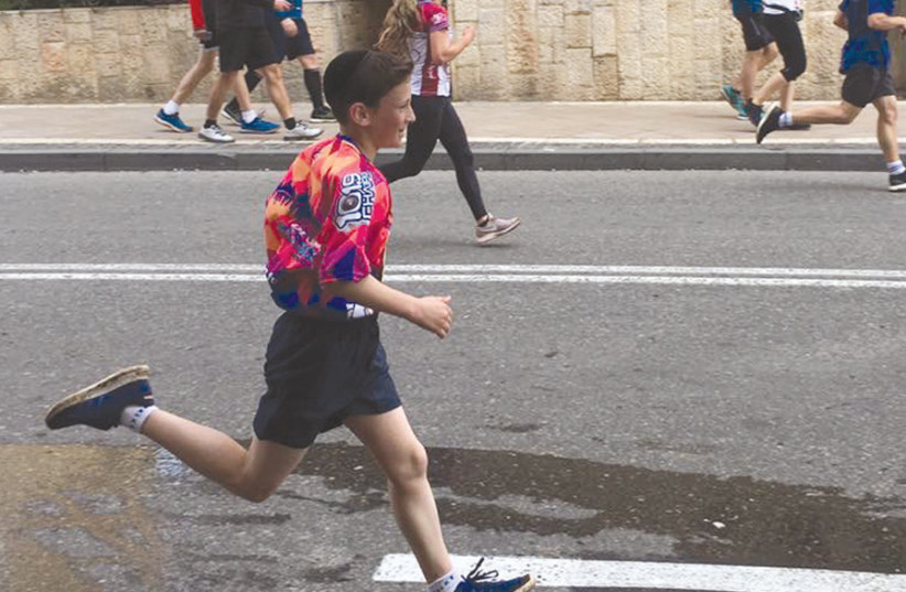 Action shot! The writer’s son runs the 10-km race in the Jerusalem Marathon (photo credit: BENITA LEVIN)