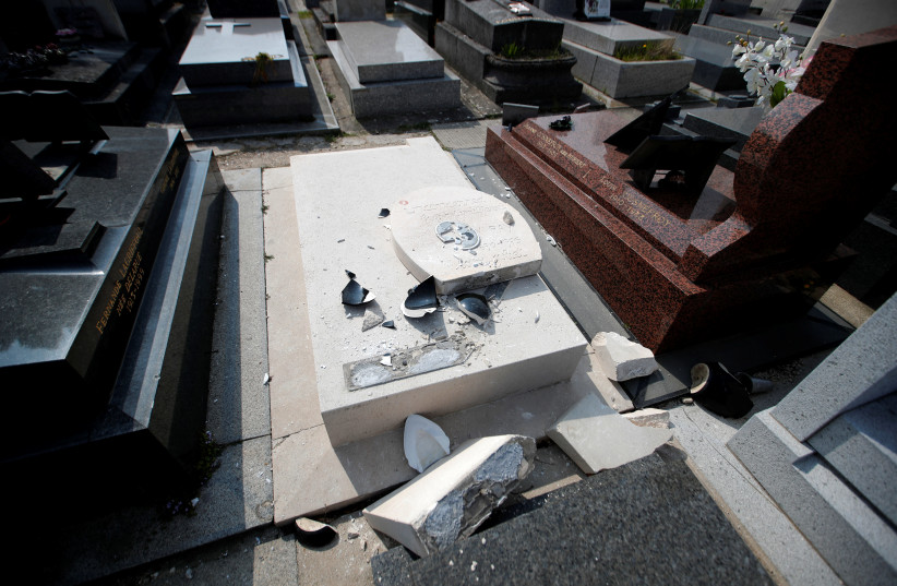 A view shows the desecrated tomb of American-born surrealist artist Man Ray and his wife in the Montparnasse Cemetery in Paris, France, March 28, 2019  (photo credit: CHARLES PLATIAU / REUTERS)