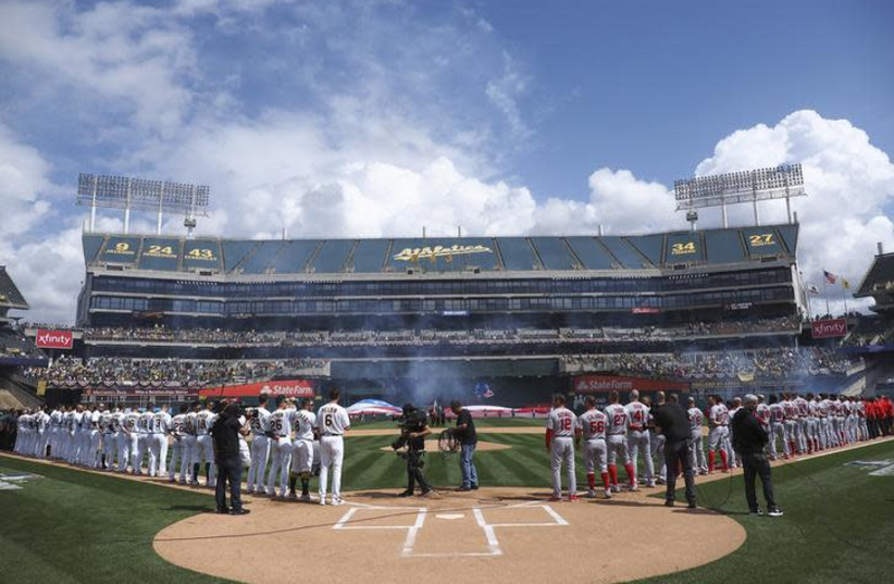 Mar 28, 2019; Oakland, CA, USA; Oakland Athletics and Los Angeles Angels players line up before the game at Oakland Coliseum (photo credit: REUTERS)