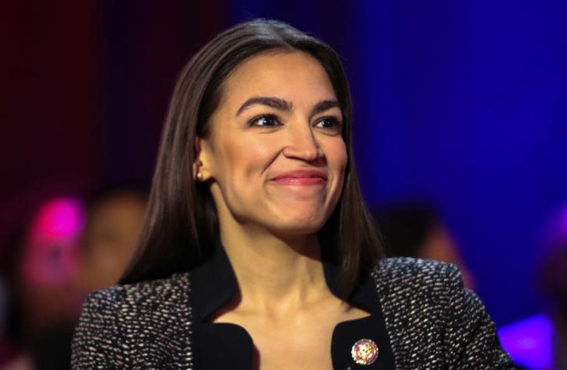 U.S. Representative Alexandria Ocasio-Cortez (D-NY) speaks to members of the media following a televised town hall event on the “Green New Deal” in the Bronx borough of New York City, New York, U.S., March 29, 2019 (photo credit: REUTERS/JEENAH MOON)
